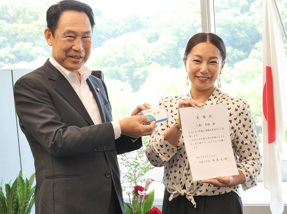 尾花市長から委嘱状と名刺を受け取る三船さん㊨
