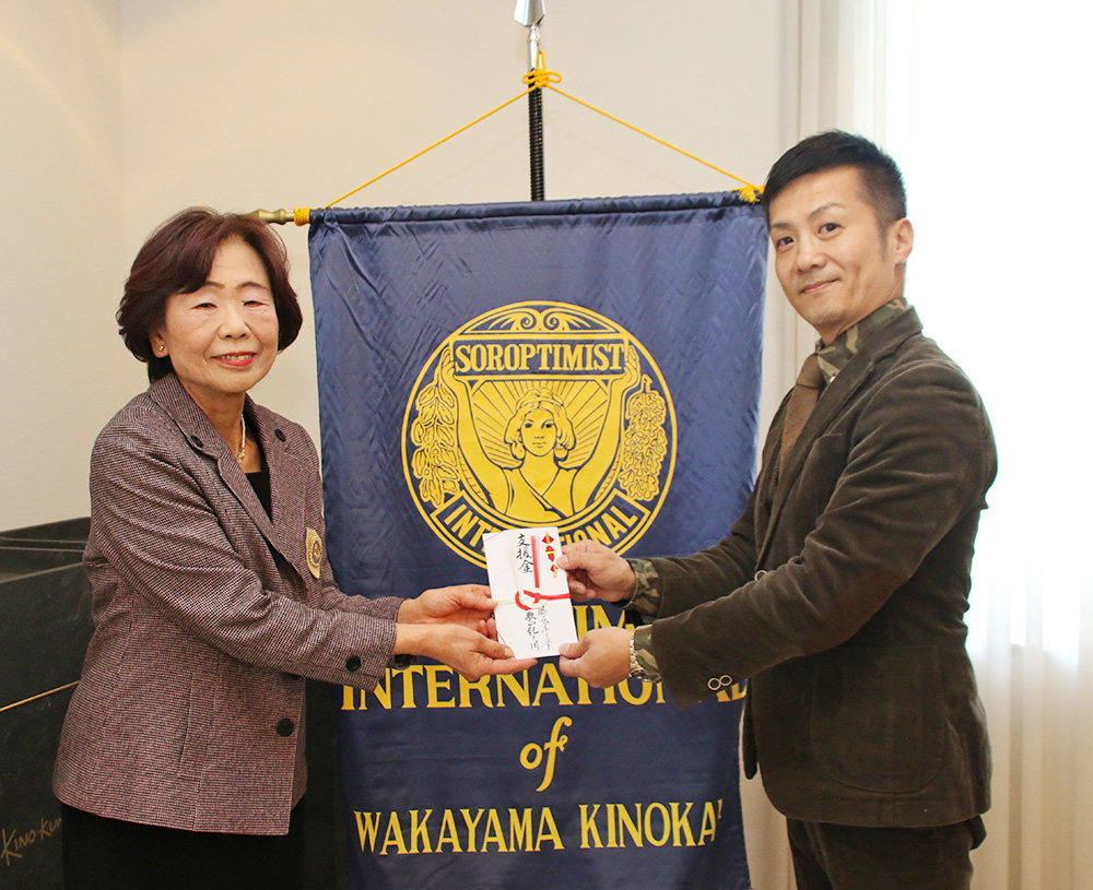 支援金を手に川端会長㊧と尾上代表理事