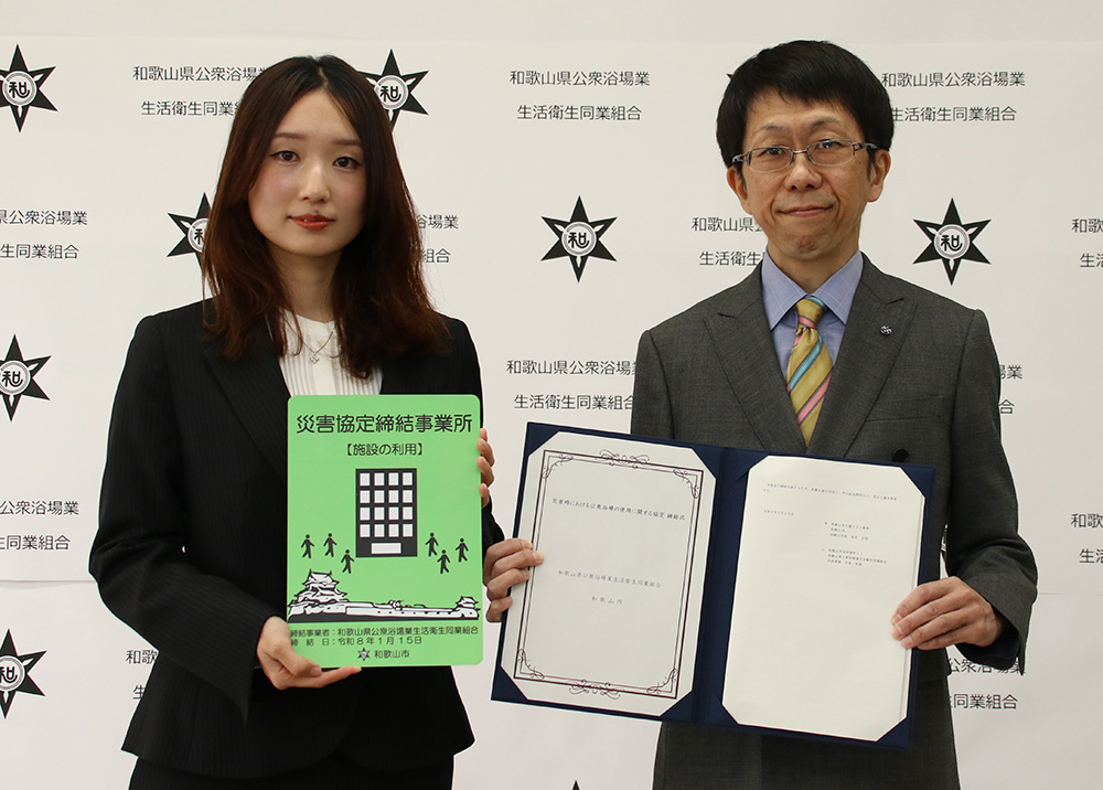 認定プレートと協定書を手に中本理事長㊧と鶴巻副市長