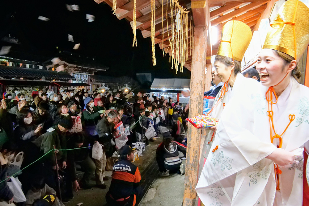 参拝客に福豆をまく年男・年女ら