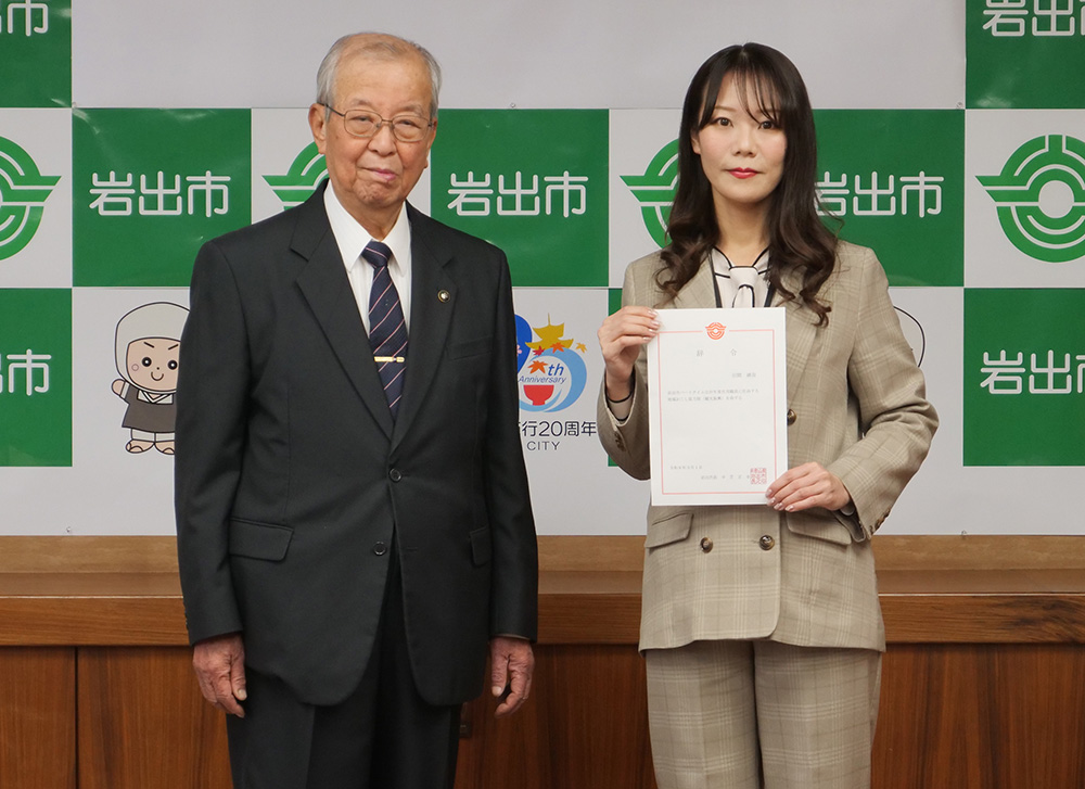 委嘱状を手に引間さん㊨と中芝市長