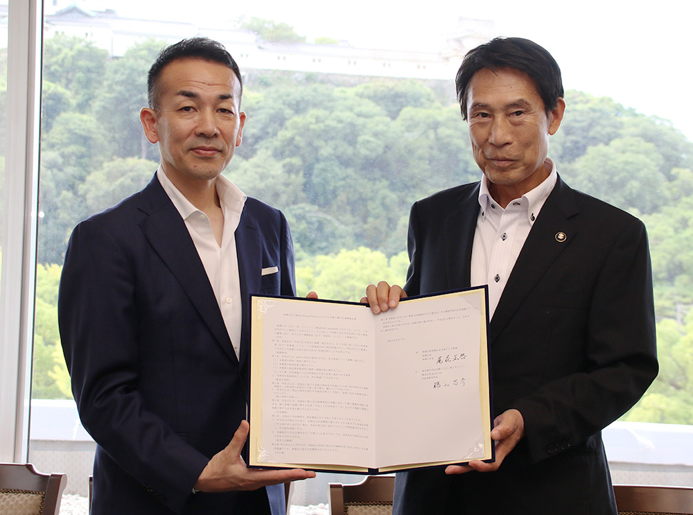 協定書を手に尾花市長㊨と藤山社長