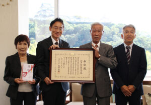 表彰状などを手に(左から)佐谷副会長、尾﨑市長、藤井会長、中島さん